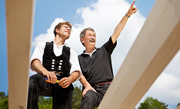 Two men working on a roof
